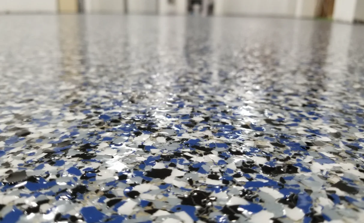 Close up of blue, black and white vinyl flake under a gloss polyaspartic topcoat